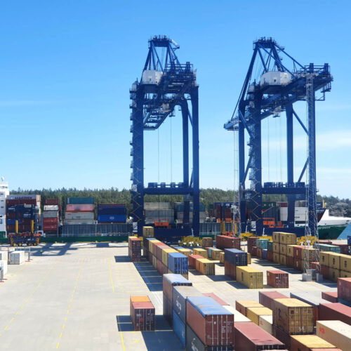 View of container yard at Hutchison Ports Stockholm with vessel docked in distance